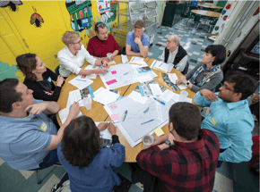 Group of people around a table having a discussion