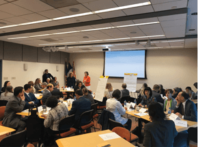 group of people in a room having a meeting